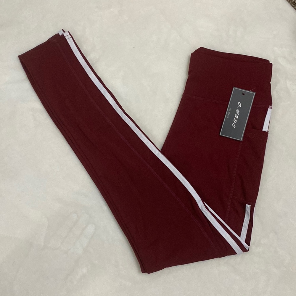 C-mode Burgundy leggings with Two white lines down outside of legs. Hip pockets